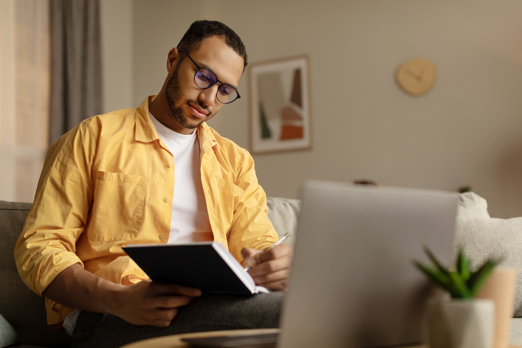 a man sitting at a table using a laptop