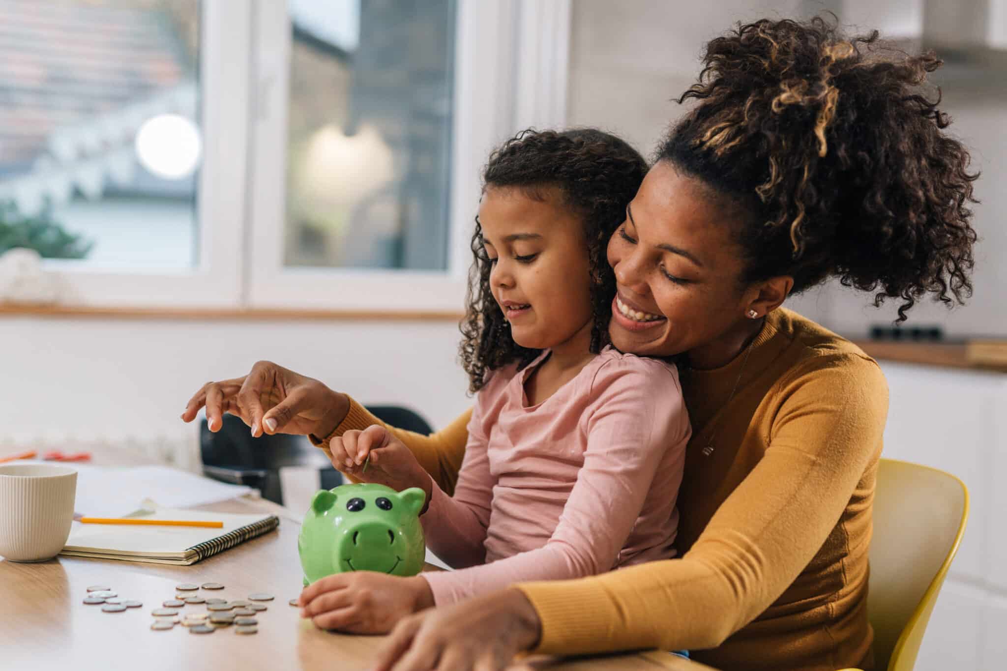 Nashville mom teaching daughter financial literacy with coins, passing on generational wealth strategies for the future.